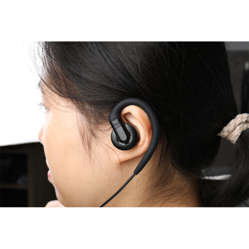 A female police officer wearing the EM-3449 radio communication earpiece while on duty, using it for task communication