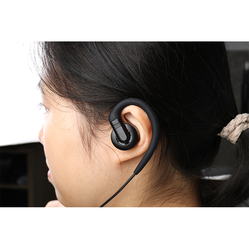 A female police officer wearing the EM-3449 radio communication earpiece while on duty, using it for task communication