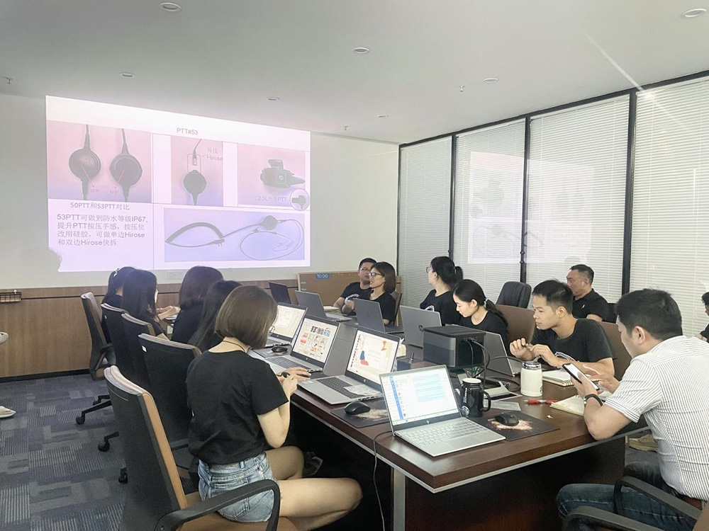 Sales staff and engineers jointly discuss the direction of new radio communication products