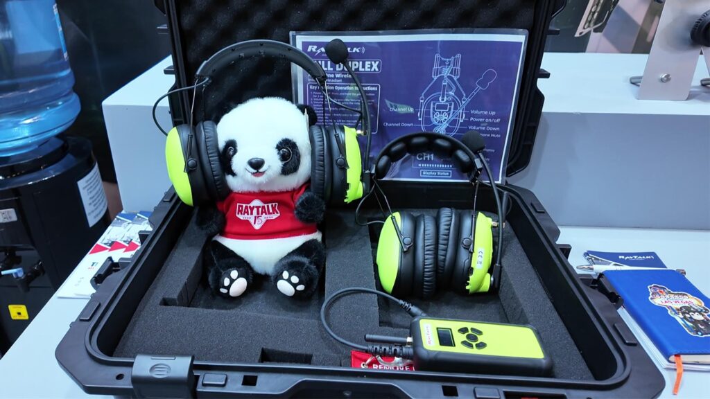 RayTalk 15th-anniversary panda plush wearing a full-duplex headset.
