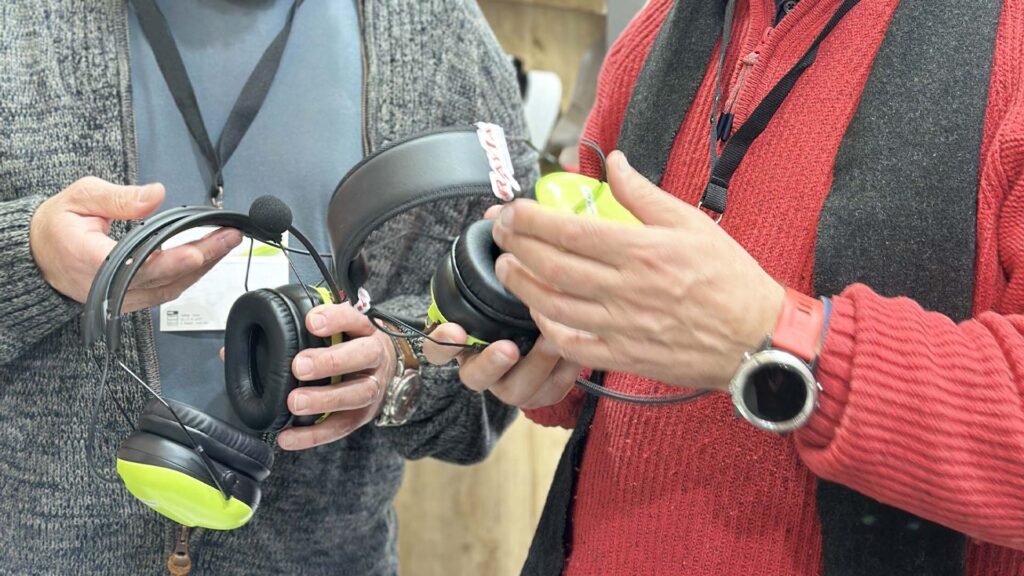 Two professional testing the latest full-duplex communication headset.
