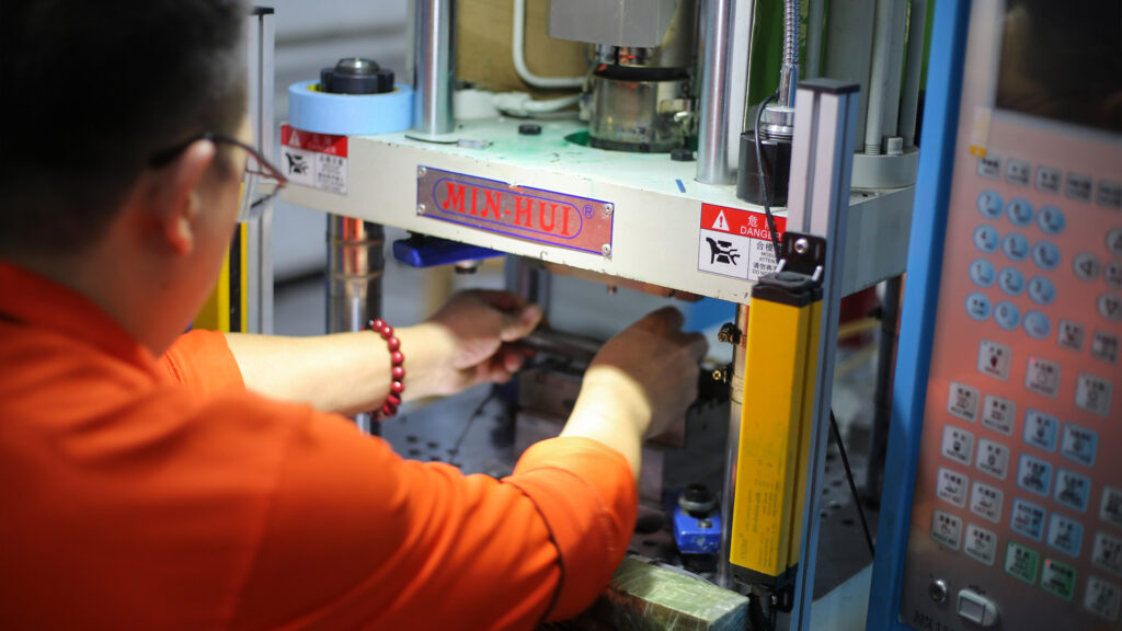 Workers injection-molding walkie-talkie cable connectors