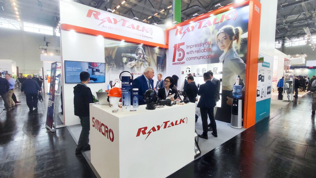 Busy booth with professionals consulting experts on-two-way radio accessories